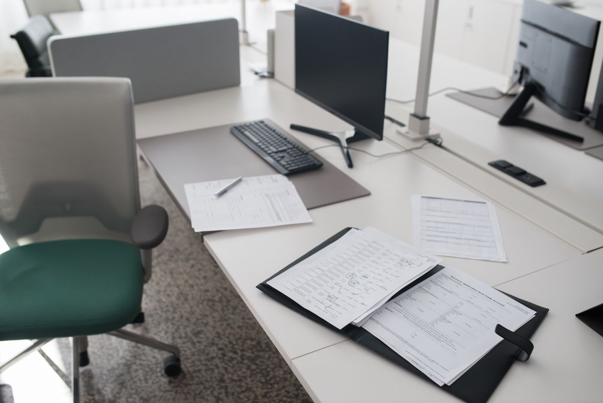 Organized office desk with structured documents and folders, representing clear documentation